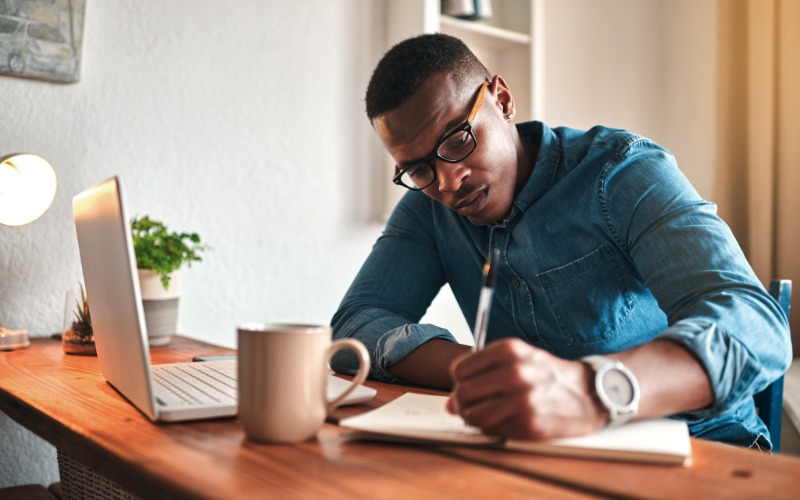 A man drafts a business plan on paper