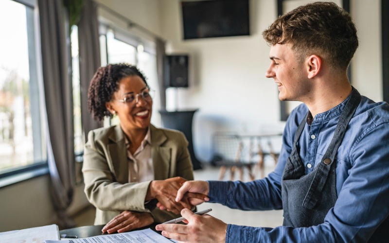a small business owner receives guidance about resources from a public servant